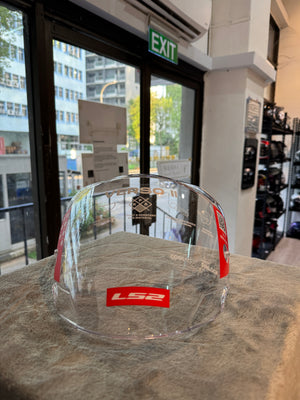 Clear LS2 OF618 Verso 2 visor standing upright on a stone counter in front of the shop window