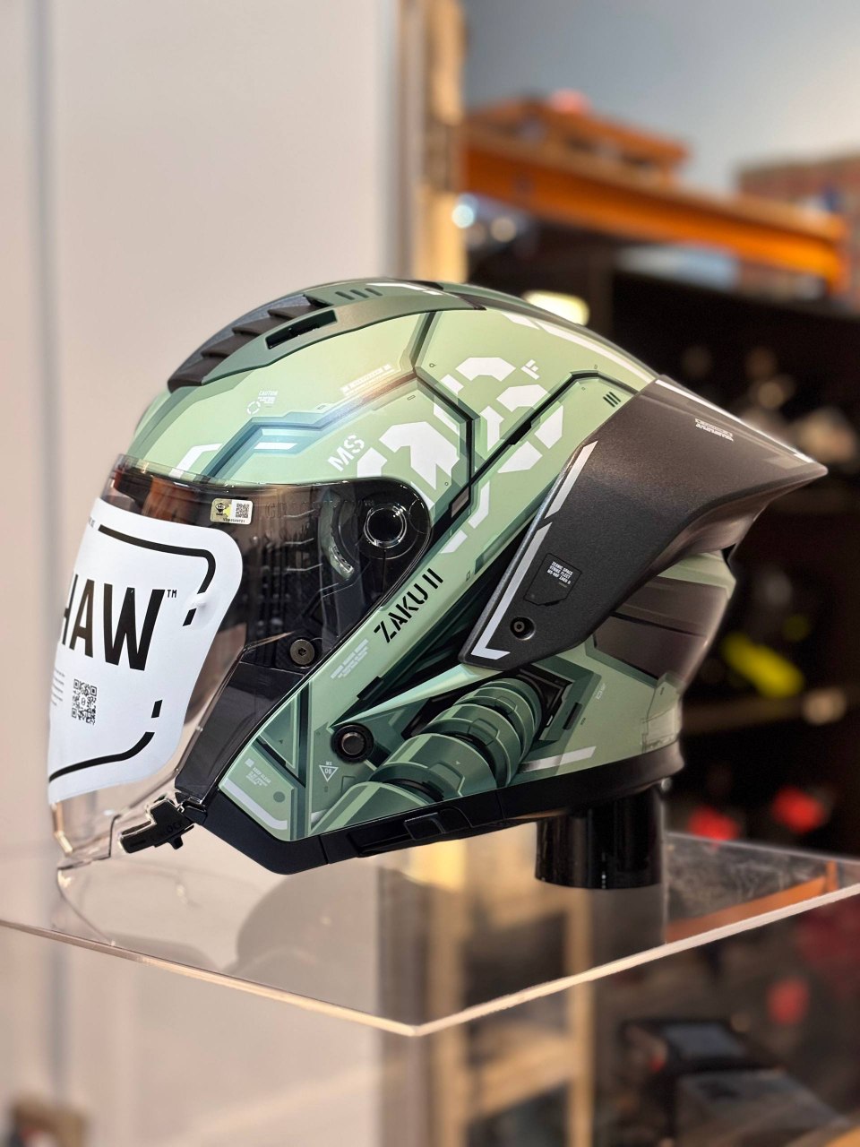 Gracshaw Gundam Collectors Zaku Green open face helmet, front three-quarter view with Zaku II graphics
